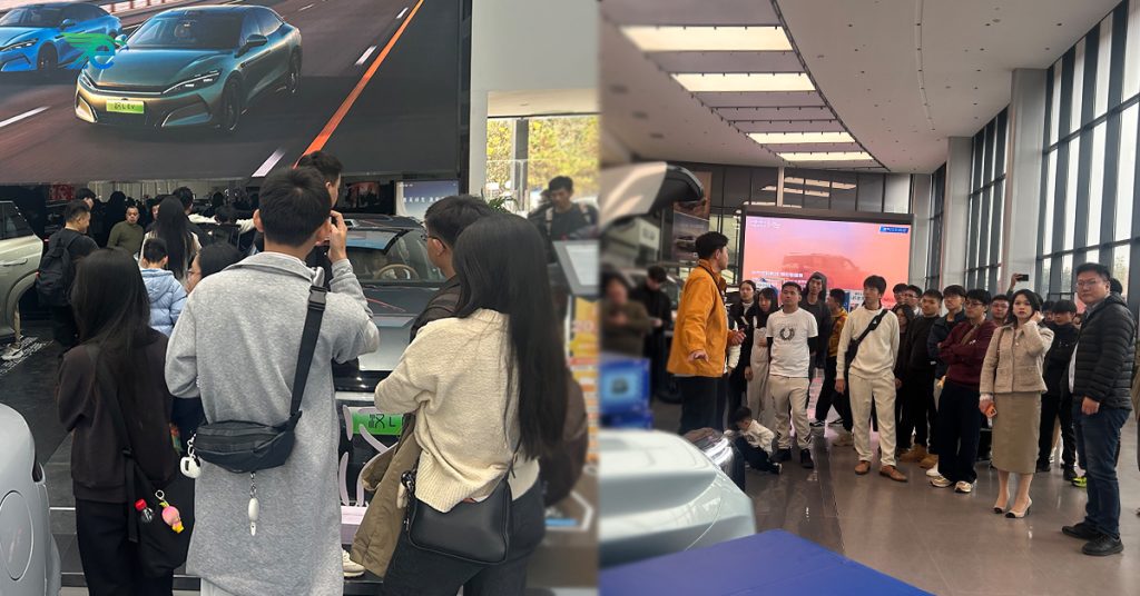 Group photo of Malaysian students and government representatives visiting the full-range BYD showroom, highlighting China–Malaysia cooperation in new energy vehicles